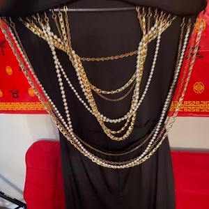 A BEAUTIFUL BLACK SEXY BLACK ONE PIECE WITH PEARLS IN THE BACK.